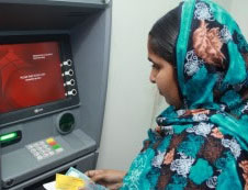 A woman using an ATM. © 2015 Minhazur Rahman