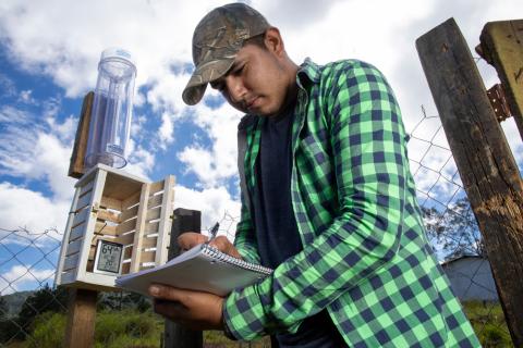 A young man in Honduras revising the amount of rainfall. © 2020 Shutterstock/Vivid Imagery