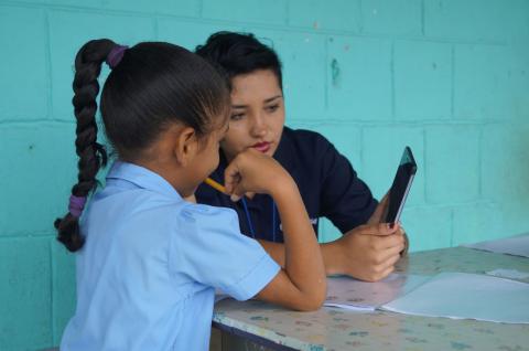 A child in Costa Rica looking at a tablet