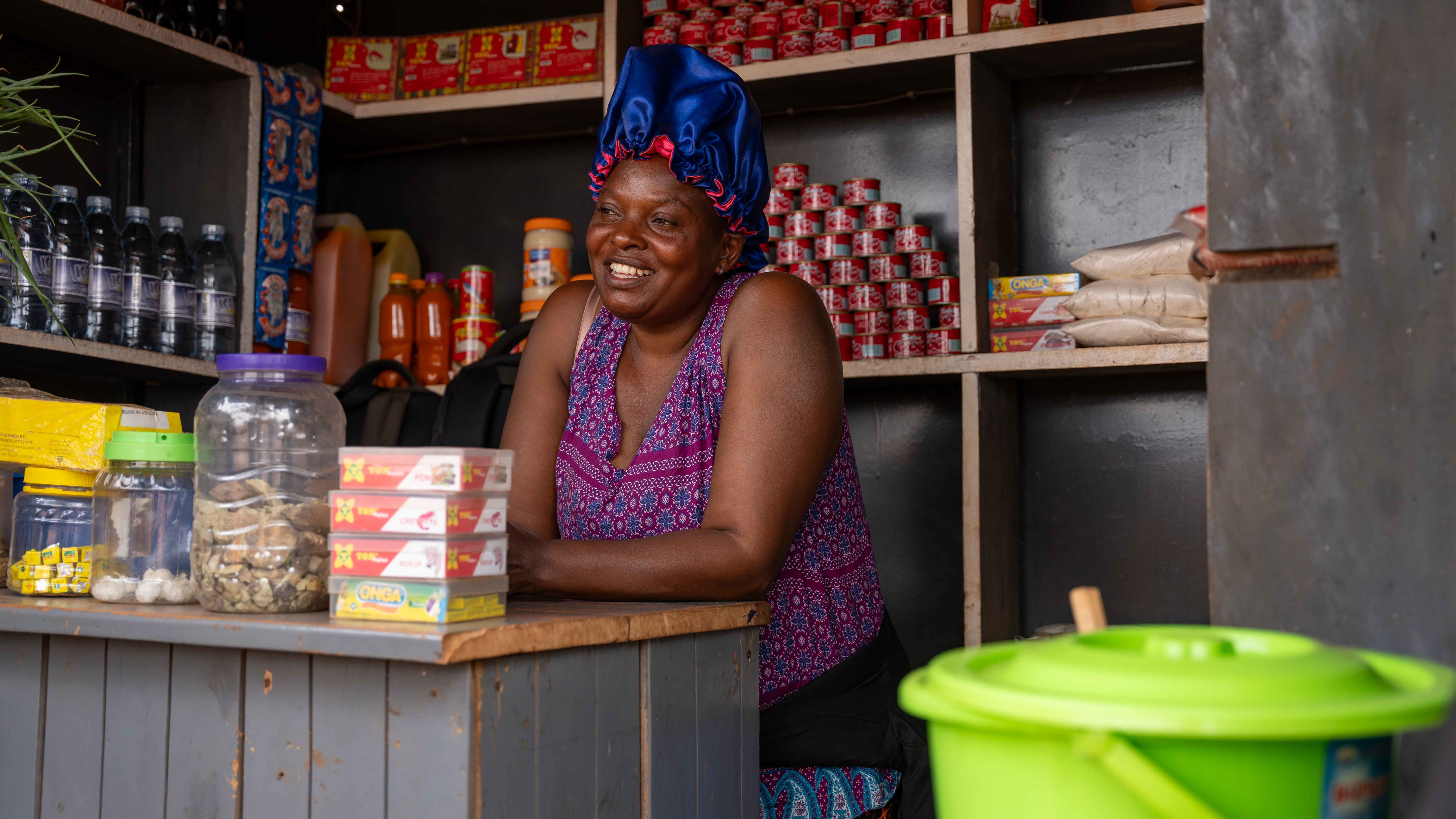 Vanesa Mukiem, a Congolese refugee and single mother of five at her grocery shop in Kampala. 18 October 2024, Kampala. Photo: Nathan Ijjo Tibaku/IRC.