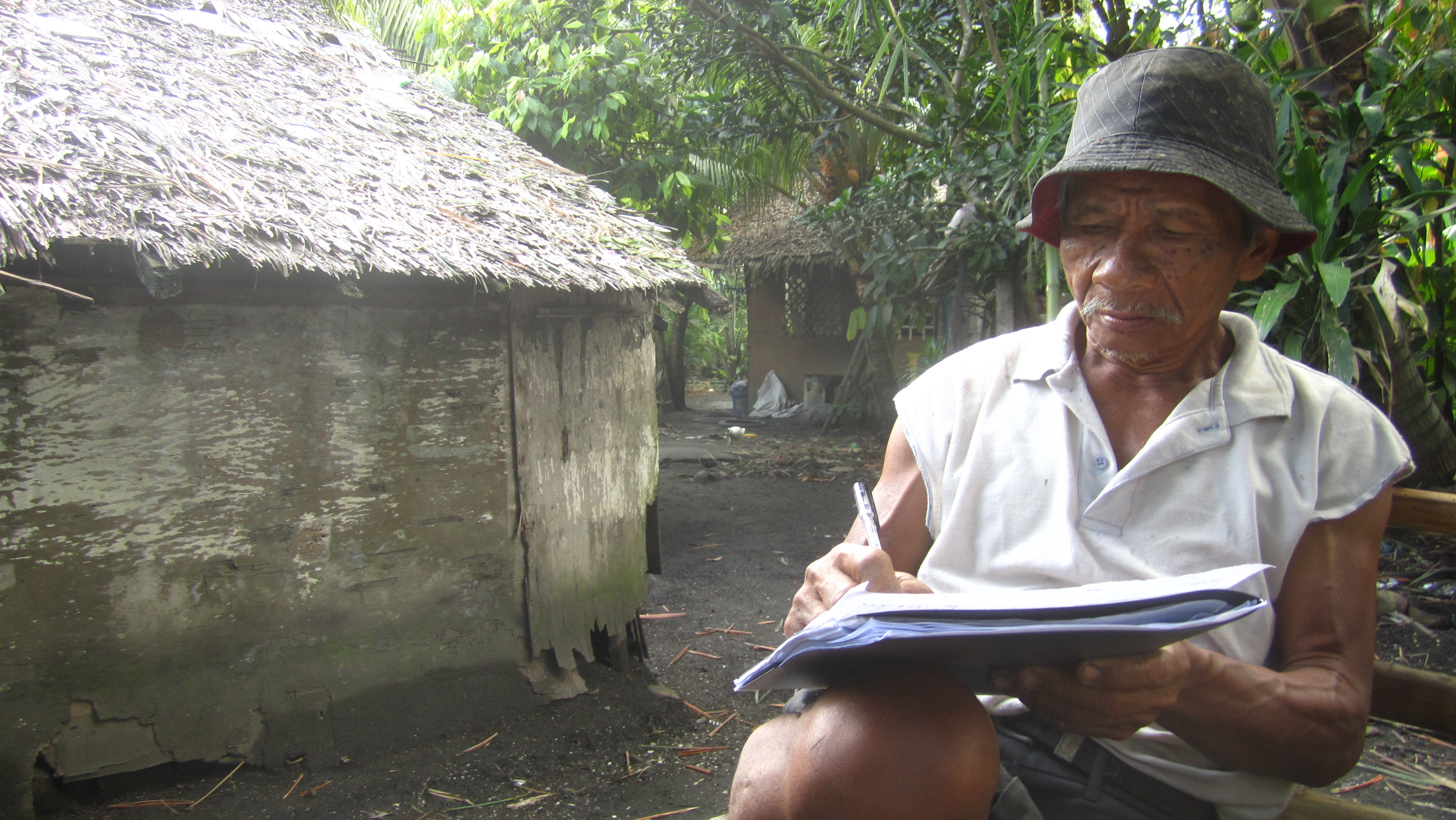 A farmer signing a payout check