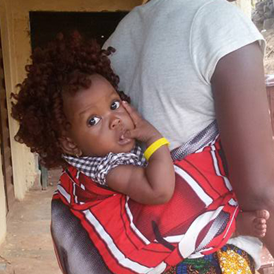 An infant in Sierra Leone with a color-coded bracelet