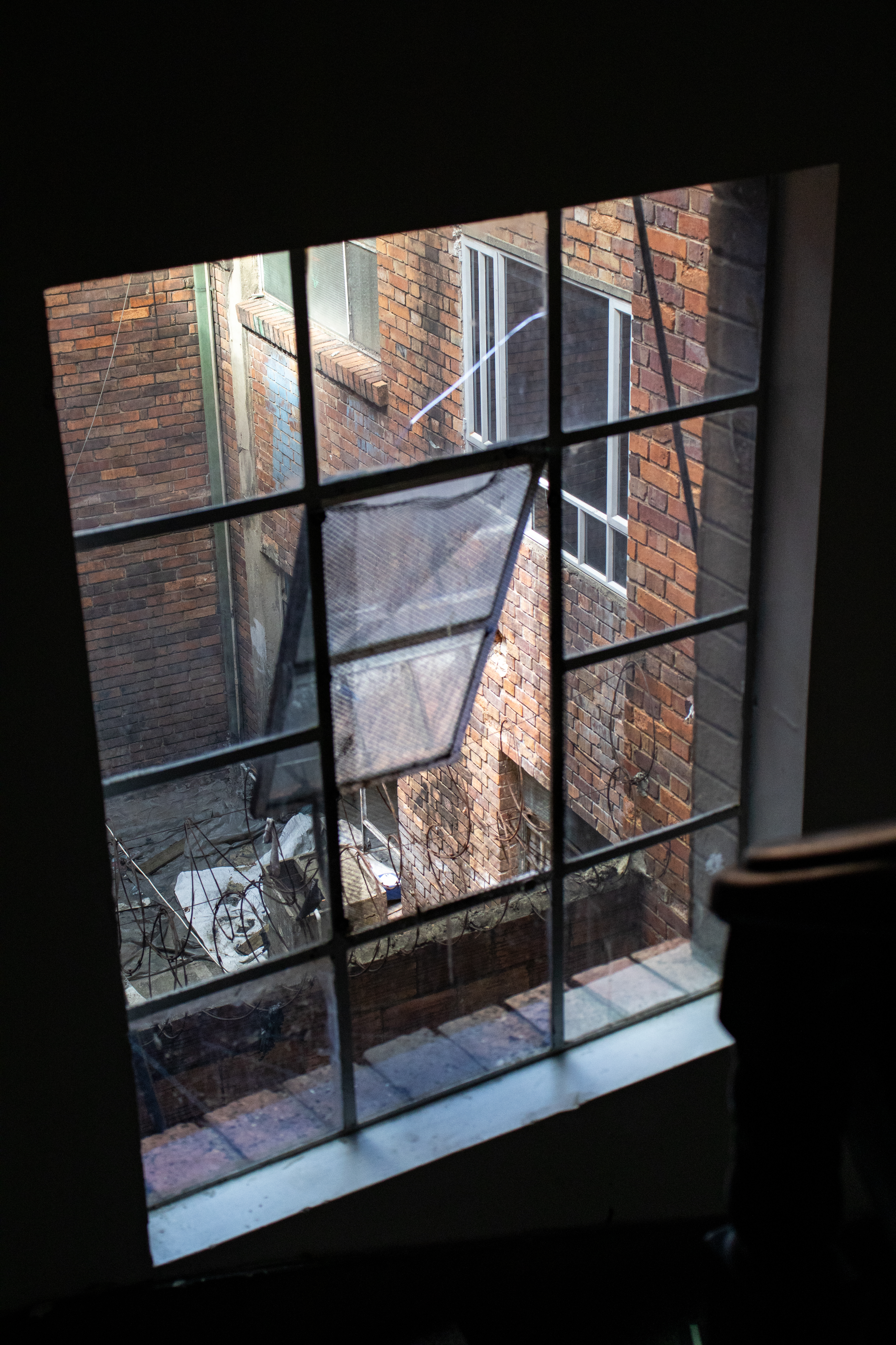 Photo of a partially open window in a neighborhood in Bogota