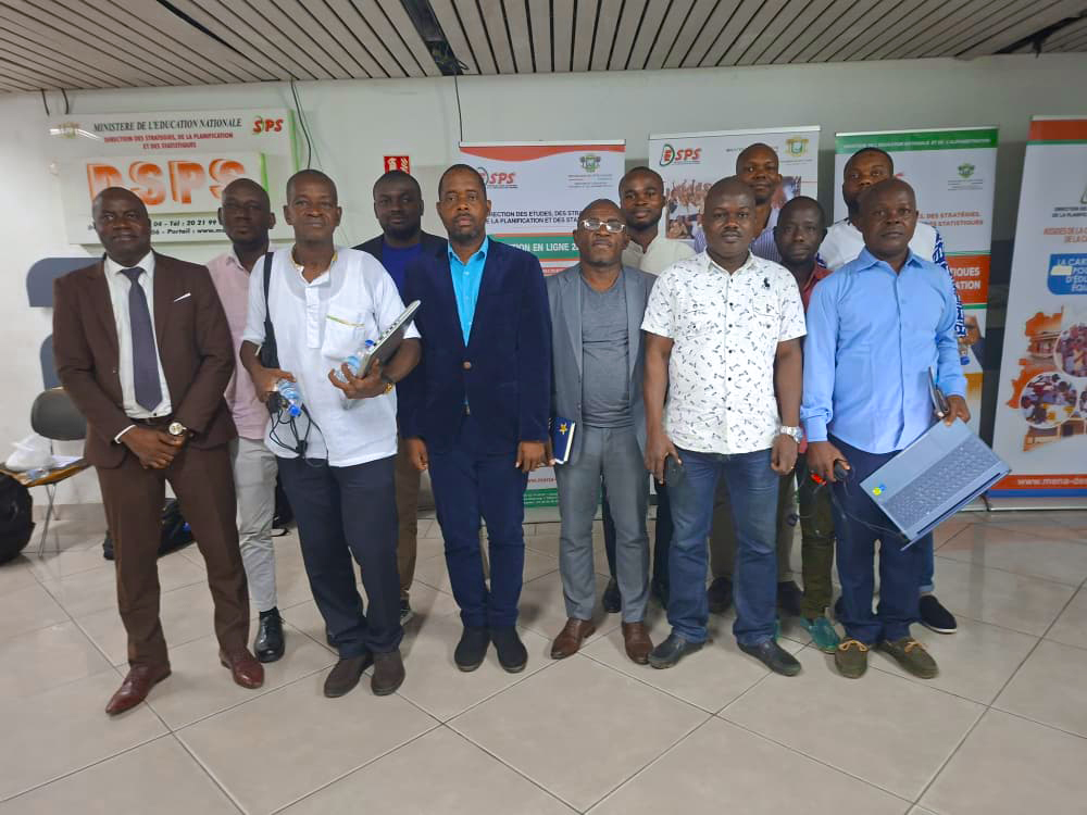 Group photo of participants taken in the hallway outside the session