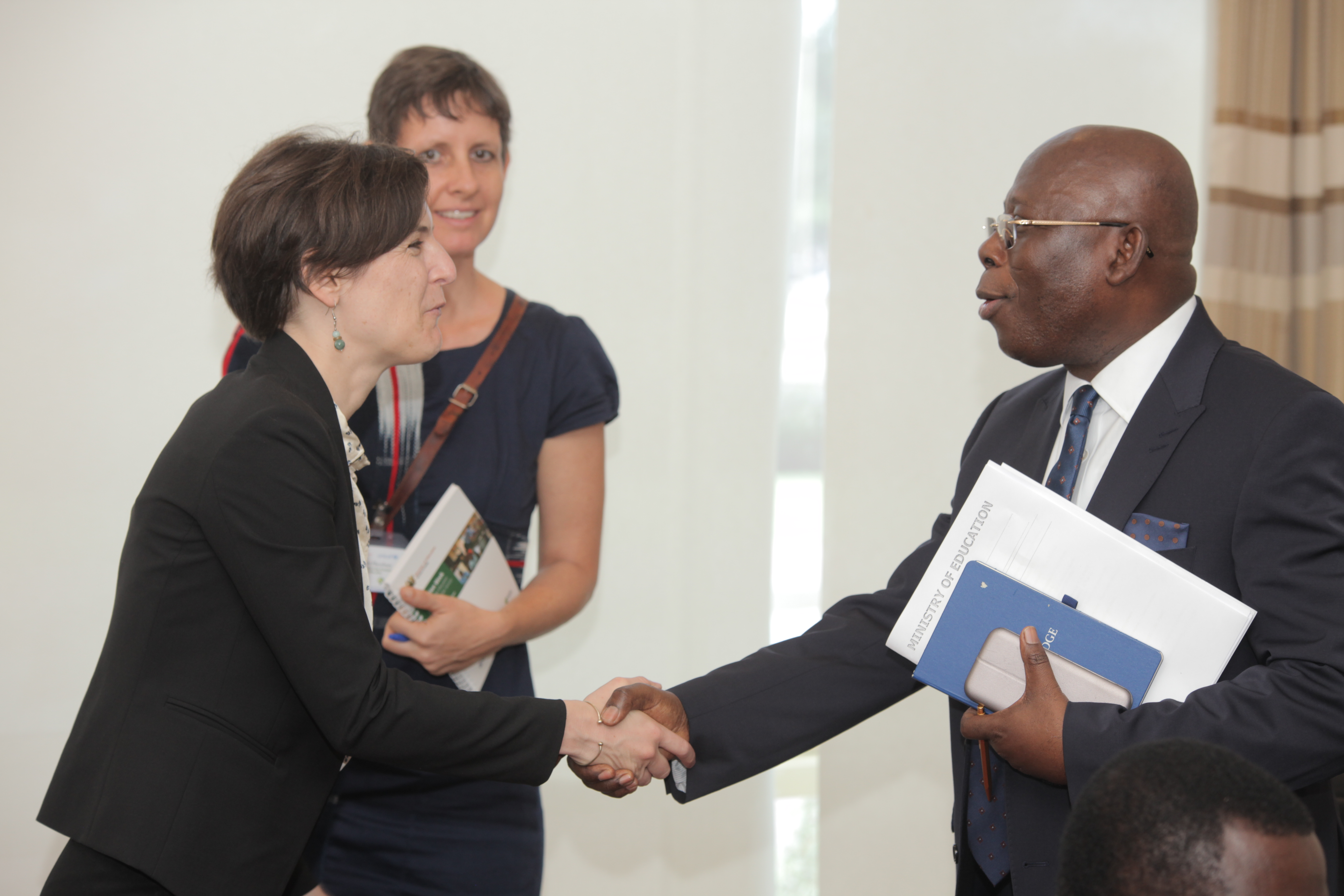 Annie Duflo, IPA Executive Director (left), Madeleen Husselman, former IPA Ghana Country Director (center background), and Enoch Cobbinah, Chief Director, Ministry of Education, Ghana, at Education Evidence Day in May 2018. © John Denanyoh
