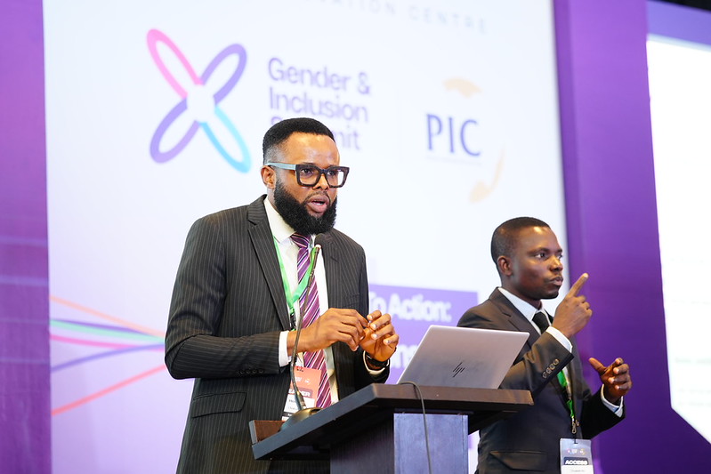 Henry speaking at the event with a live interpreter onstage for his presentation