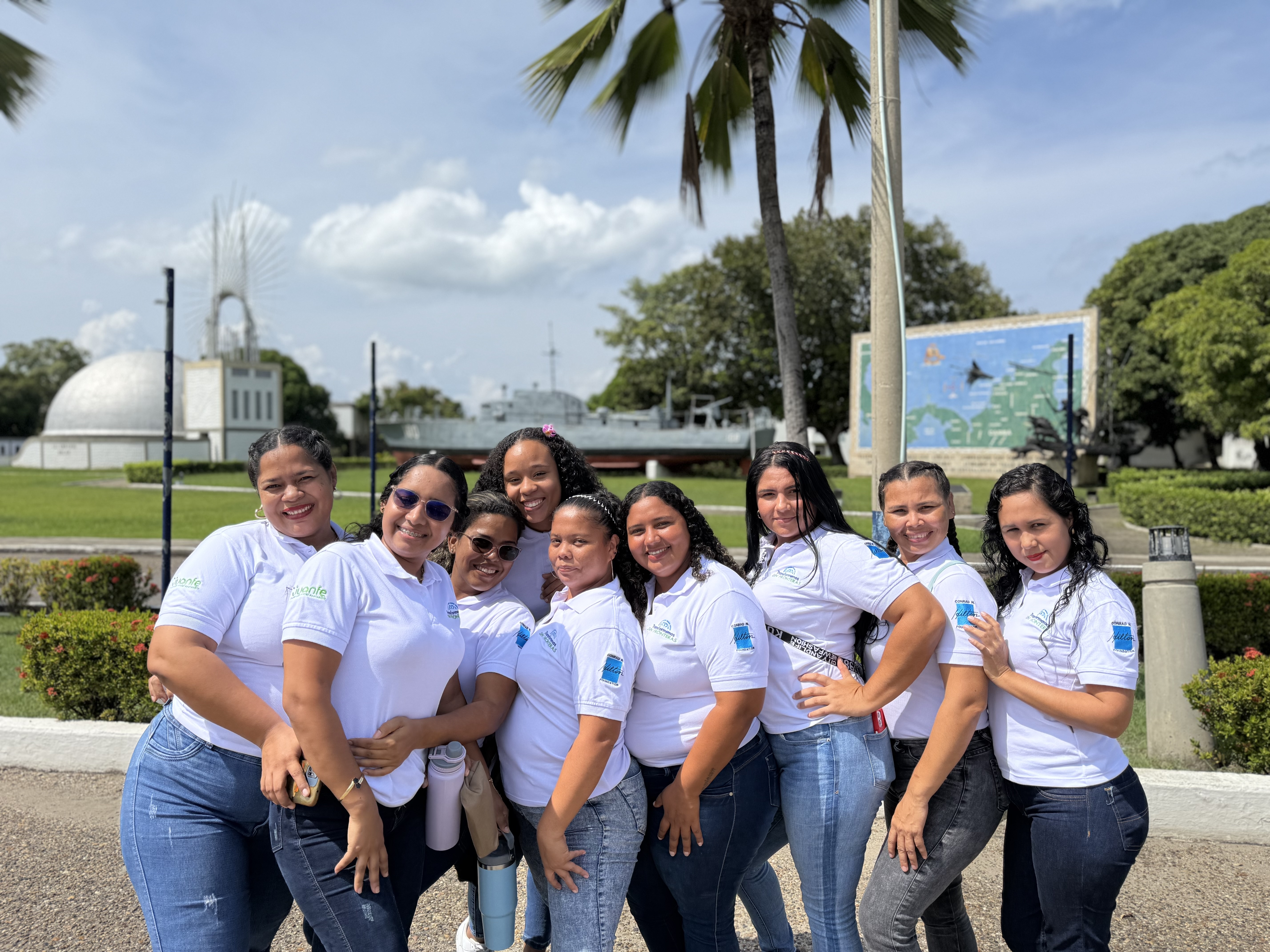 Women participating in a Fundacion Juanfe program standing outdoors wearing matching T-shirts with the Juanfe logo