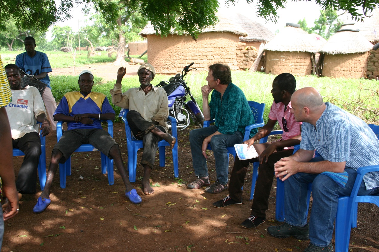 Dean Karlan and Chris Udry in Ghana with IPA field staff and study participants.