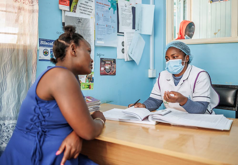 A pregnant woman attending a check-in with a healthcare provider in Kenya. 