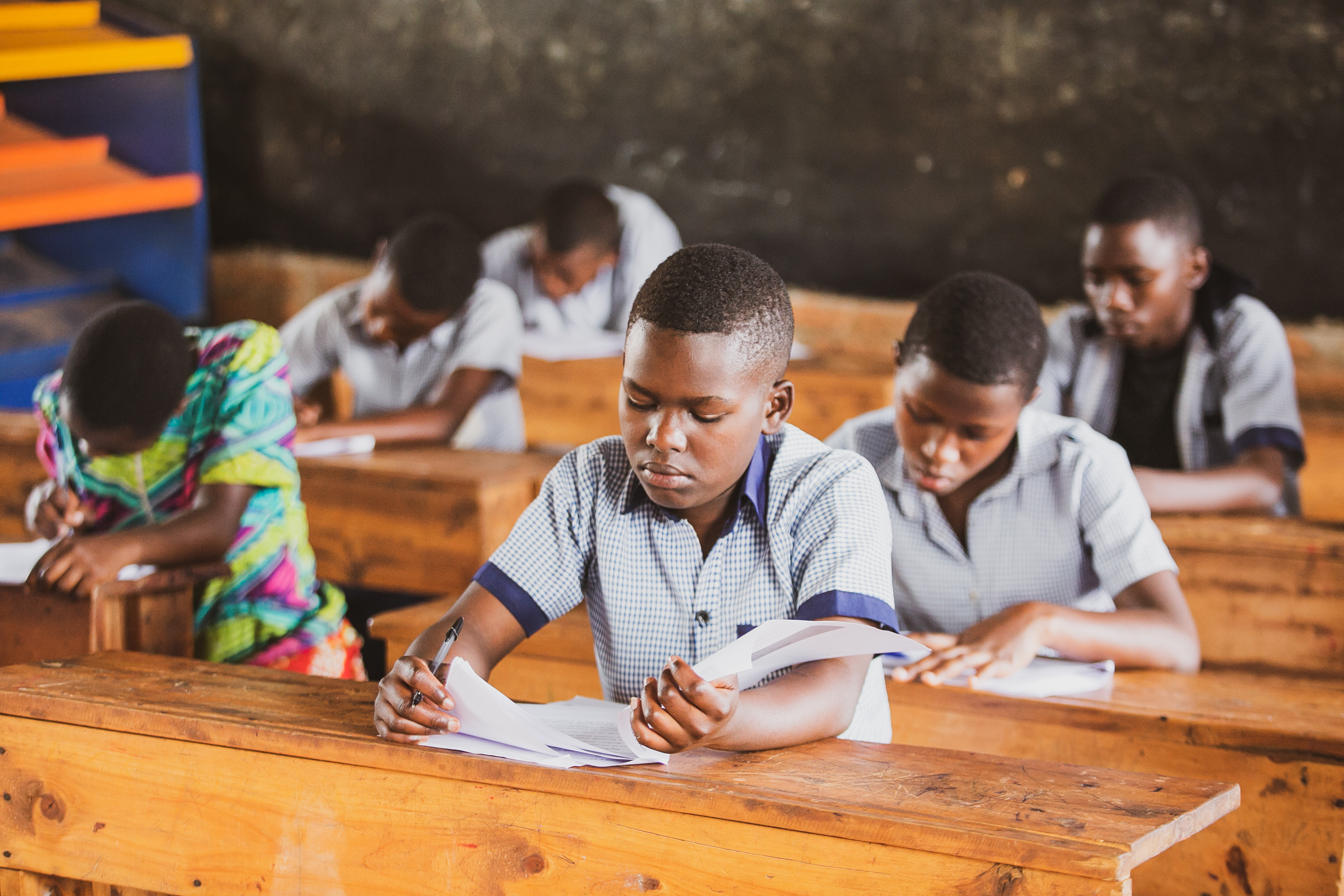 Photo of students completing assigned work in a classroom in Rwanda