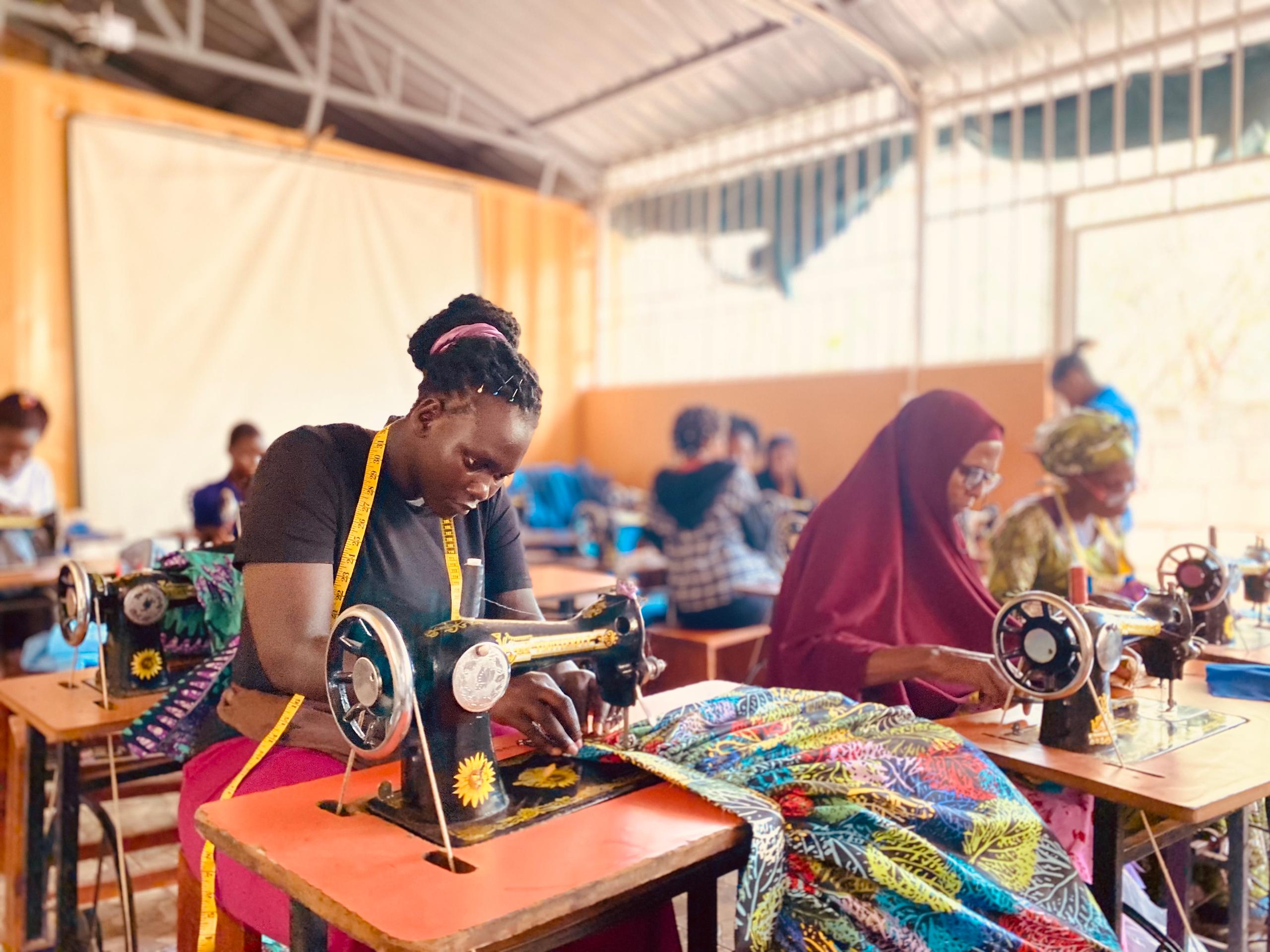 Women in a room using sewing machines