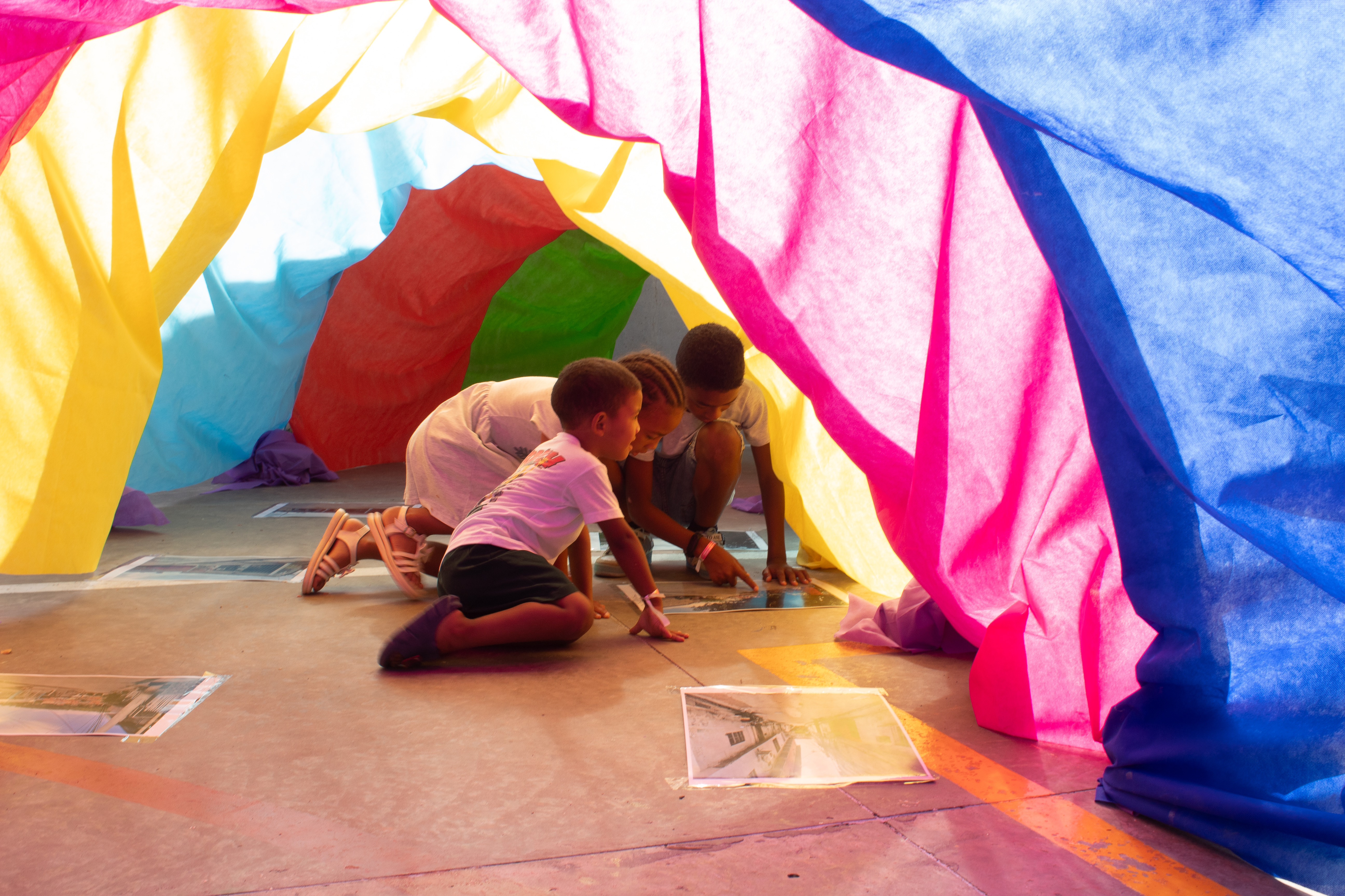 Photo of children under a play tent