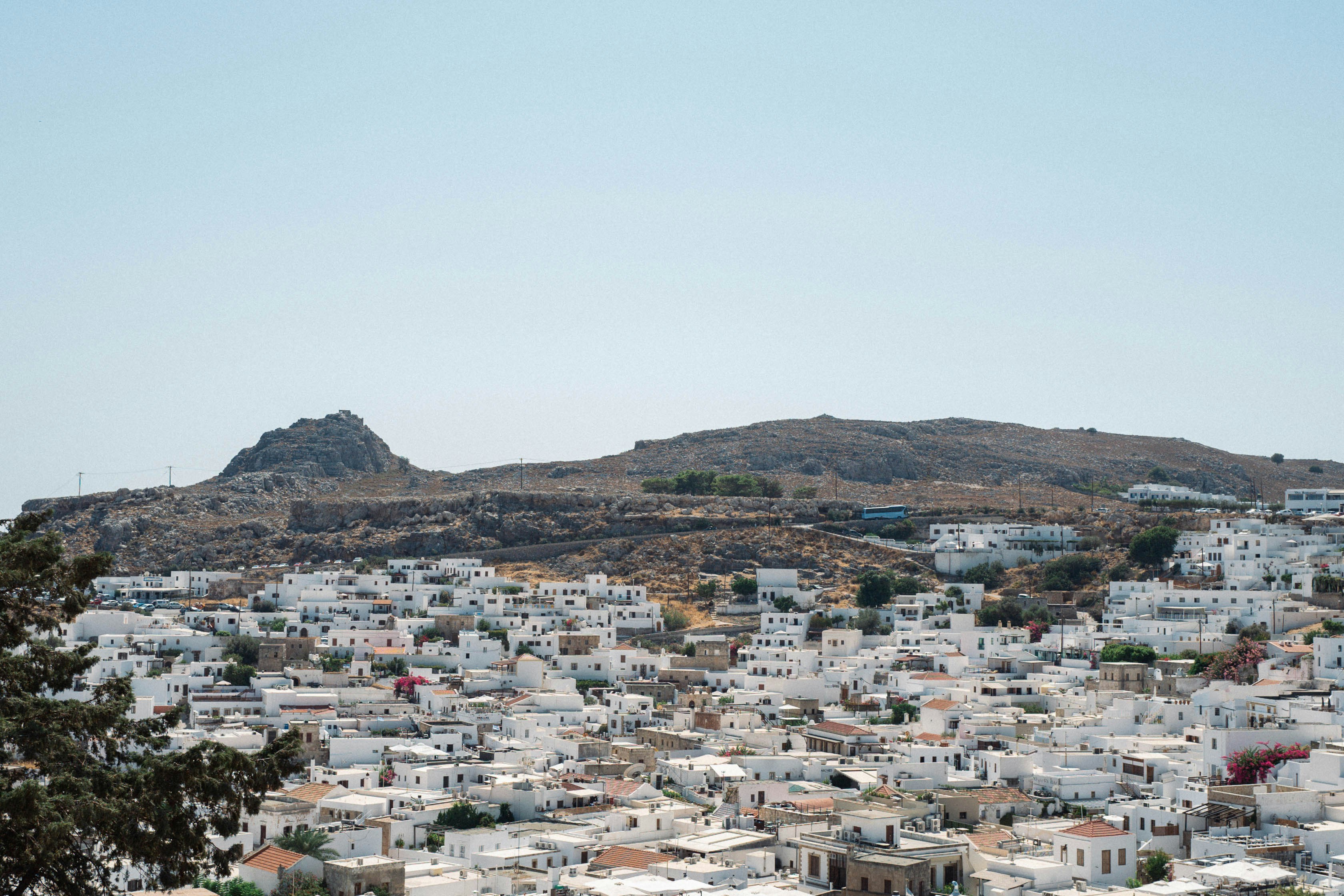 A city with a hill in the background in Greece.