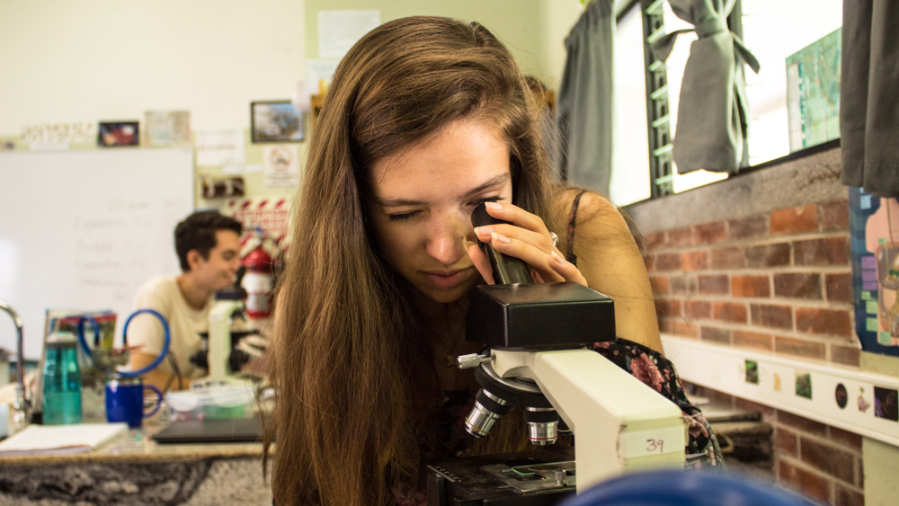 Santa Ana, Costa Rica-A female secondary school student looking through a microscope during biology class ©2018 Margus Vilbas/Shutterstock