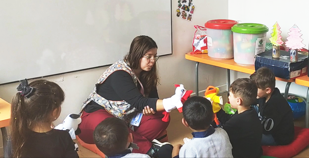 Early childhood development worker playing with children.