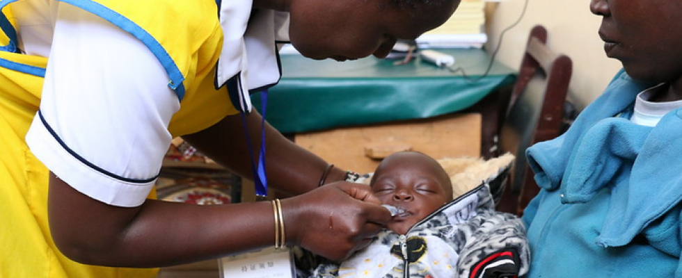 A health worker administering a vaccine to an infant. © USAID