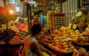 A Filipino micro entrepreneur works at his fruit stand