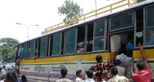 Migrants board a bus in Bangladesh
