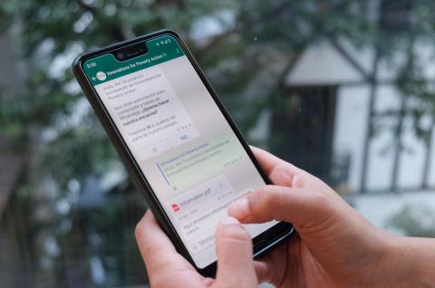 Photo of IPA sending SMS messages on a smartphone to obtain consent from prospective IPA survey participants to contact them via WhatsApp