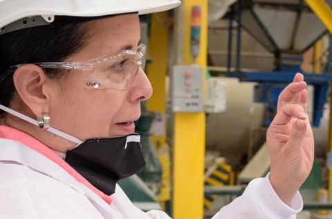 Product manager showing how the product gets ready after the mixing process in an agricultural chemical manufacturing company