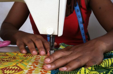 A tailoring apprentice in Ghana using an overlocking sewing machine. © 2014 Morgan Hardy