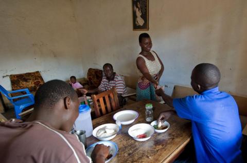 A small-business owner can be seen serving patrons in her restaurant in Nkhoma, Malawi. (©Bill & Melinda Gates Foundation/Barbara Kinney)