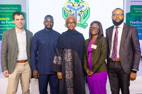 Team members of IPA William Blackmon, Brian Mwesigwa, Funmi Ayeni, and Henry Chukwu with Habib Amina Ahmed (center), the Director of the Consumer Protection Department at the Central Bank of Nigeria. © 2024 Atanda Creative Studios