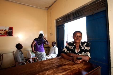 A mobile banking customer with her phone in Uganda. © 2013 Will Boase