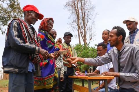 Photo of farmers receiving money. © Michael Tewelde