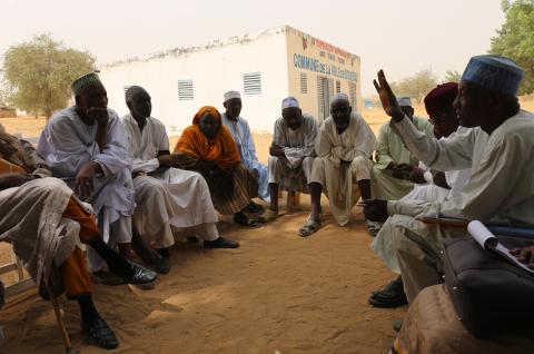 A group of men and women discussing during a village meeting. © 2017, Xavier Boulanger from Shutterstock