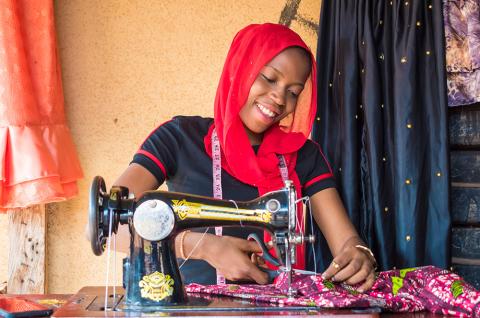A woman using a sewing machine. © 2023 i_am_zews on Shutterstock