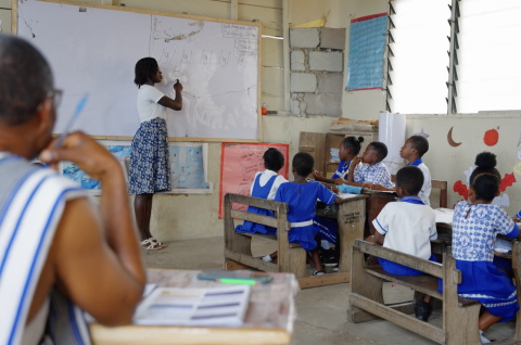 A classroom instructor in a classroom with school children