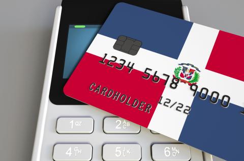 Payment or POS terminal with credit card featuring flag of the Dominican Republic. © Novikov Aleksey on Shutterstock
