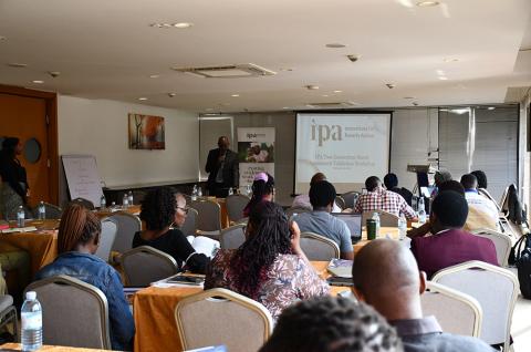 Obed Kambasu, Policy Manager for IPA Uganda, gives a presentation at the validation workshop.