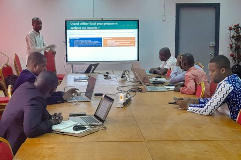 Photo of participants sitting at a table while engaging in the Excel data analysis session