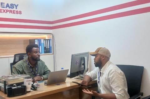An enumerator speaking to an employer with a vacancy.