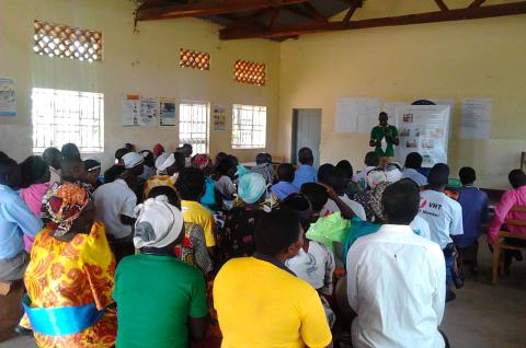 A community meeting in Uganda to discuss health center performance. © Doug Parkerson