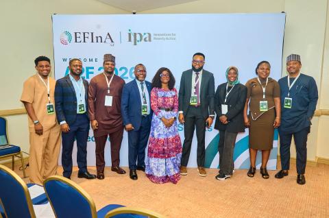 Group photo of attendees at the event standing in front of IPA and EFInA signage