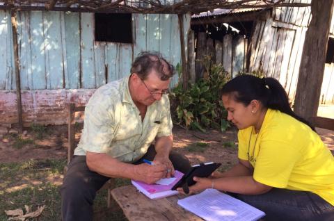 A surveyor working with a study participant.