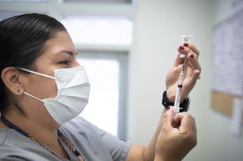 A health worker with a needle
