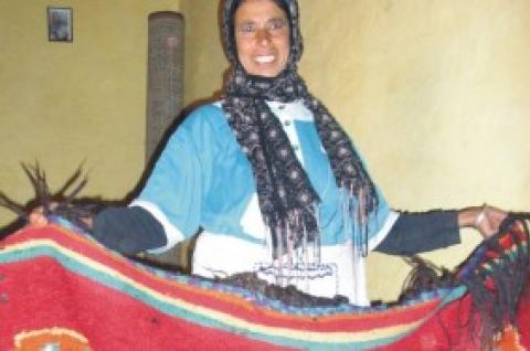 Photo of a woman showing off a carpet