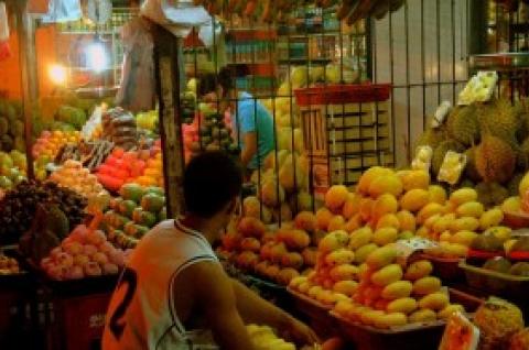 A Filipino micro entrepreneur works at his fruit stand