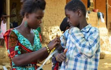 A Zambian health worker administers medicine